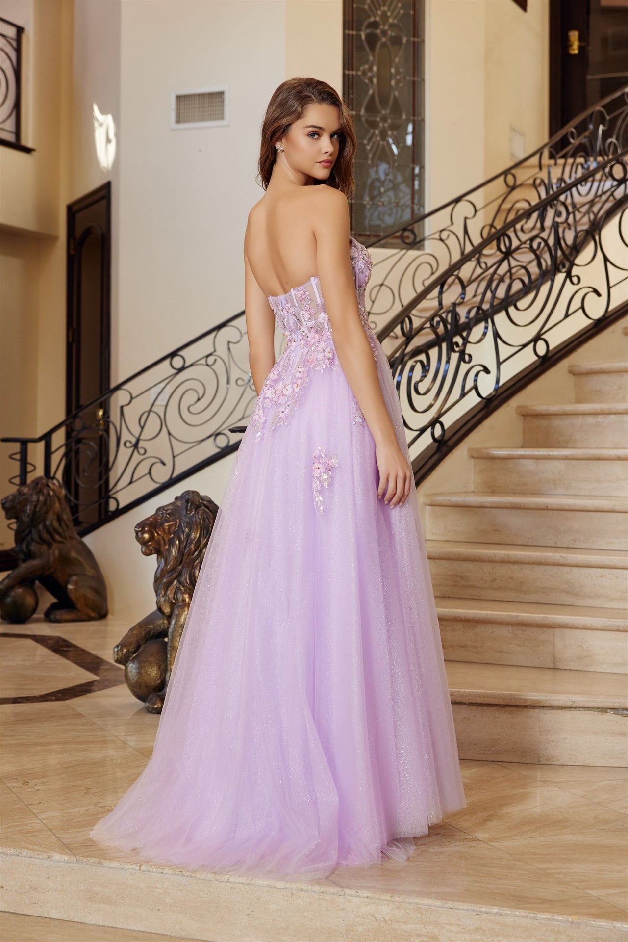 Elevate your prom night with this stunning Nox Anabel Q1773 gown. The strapless sweetheart neckline and fitted corset bodice create a flattering silhouette, while sheer floral detailing adds romantic sophistication. The fit-and-flare skirt flows gracefully into a dramatic slit train, offering both elegance and movement. Perfect for making an unforgettable entrance at formal events, this dress combines timeless design with contemporary flair for a show-stopping look.
Sizes: 00-14
Colors: Lilac