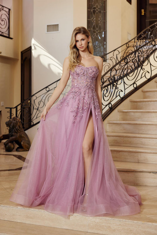 Elevate your prom night with the Nox Anabel G1371, a stunning strapless sweetheart gown that commands attention. This A-line silhouette features a sheer corset bodice adorned with intricate floral sequin beading that catches light with every movement. The dramatic slit and train add sophistication and movement, creating an unforgettable entrance. Perfect for those seeking a balance of elegance and modern glamour, this dress transforms you into the star of the evening.
Sizes: 00-16
Colors: Dark Rose, Sage