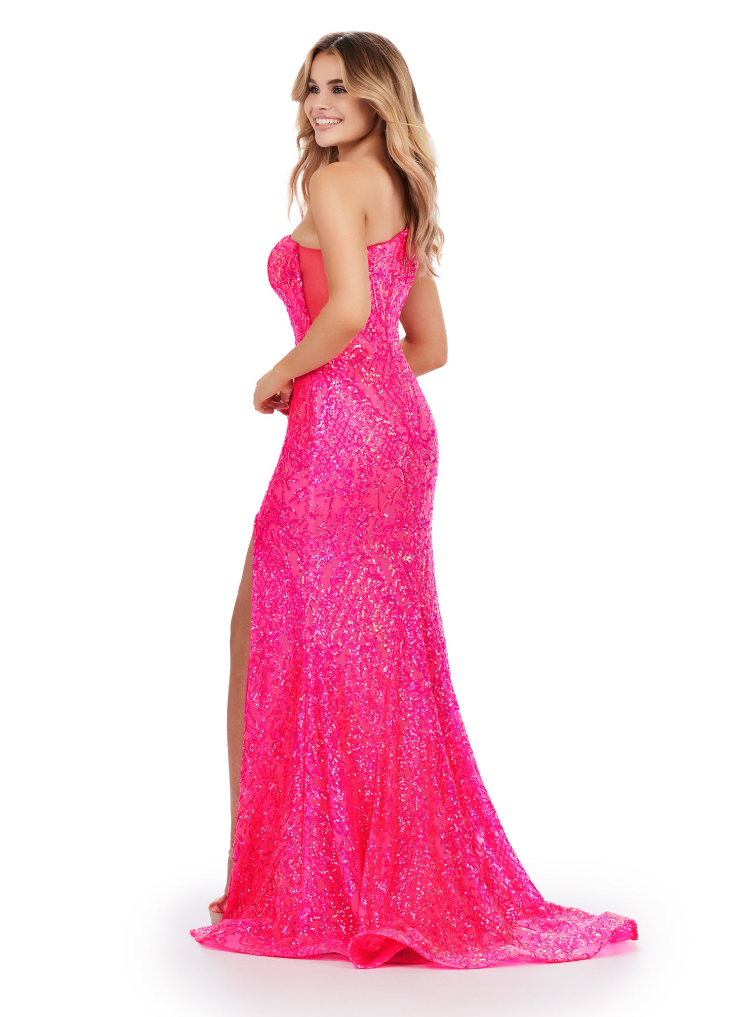 The Ashley Lauren 11471 Long Prom Dress is expertly crafted with a fitted one shoulder design and stretch sequin material, creating a stunning formal pageant gown. Stand out with its sleek silhouette and comfortable fit, perfect for your next special occasion. This memorable one shoulder stretch sequin gown features an illusion cut out side and left leg slit.