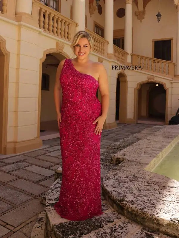 Make a statement in Primavera Couture's 14047 Plus Size Sequin Prom Dress. Designed to hug your curves, this dress features an asymmetrical one shoulder neckline, Sequins, beading and fringe detail. For a glamorous look, pair it with strappy heels and a small clutch. Sizes: 14W-24W Colors: Black, Fuchsia, Platinum