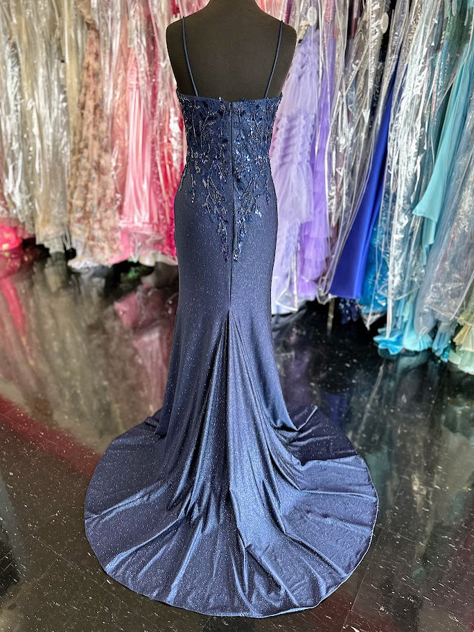 The Nina Canacci 1591 in size 4 is a navy long fitted evening gown designed with shimmering sequins and delicate lace accents. This elegant dress contours the body for a flattering silhouette, making it an excellent choice for prom or as a sophisticated mother-of-the-bride gown. Its refined details and luxurious fabric ensure a polished, graceful appearance for any formal occasion.
Size: 4
Color: Navy