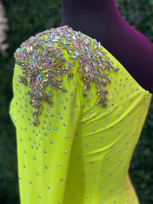 This Johnathan Kayne 2785 dress is perfect for your homecoming event. It features a single crystal shoulder, long sleeve with crystal wrist line, and stoned bodice for a sparkling look. It is also fitted for a flattering silhouette. Perfect for a memorable night. Sizes: 4 Colors: Neon Green