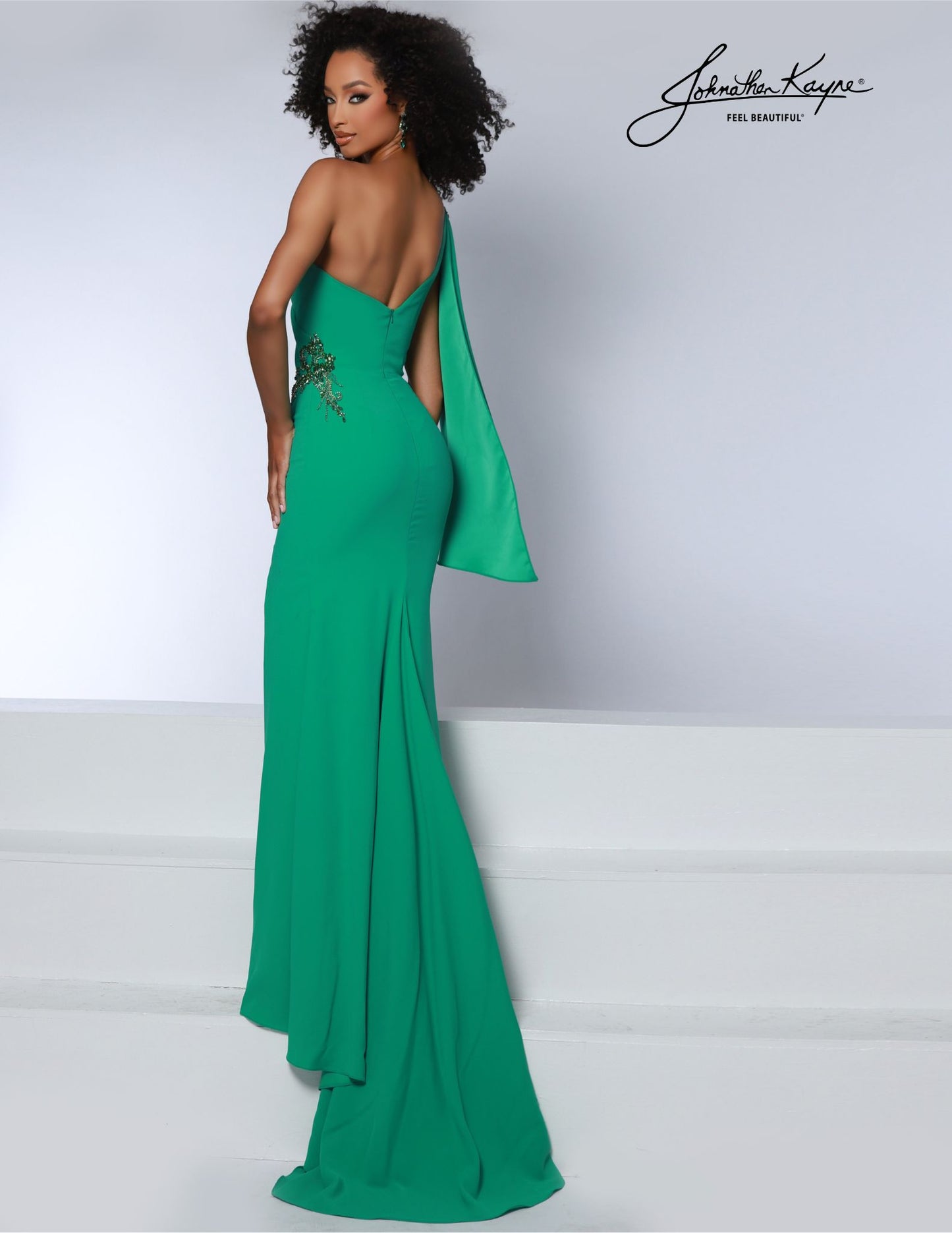 The Johnathan Kayne 2864 long prom dress features a one-shoulder silhouette and crepe fabric with encrusted crystals for an elegant look. The slit tail and high side slit add a touch of drama to make a lasting impression. This formal and pageant gown is perfect for special occasions. Get ready to take the crown in our one-shoulder stretch crepe gown. Adorned with stunning encrusted crystals on the one shoulder bodice and side, this gown is a regal masterpiece of style and grace.