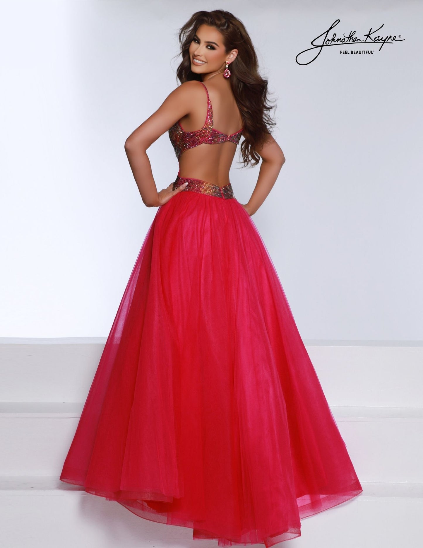 Make an unforgettable entrance with the Johnathan Kayne 2870 prom dress. A-Line tulle design features ombre stones, a plunging neckline, and elegant long cut. Make sure all eyes are on you at your formal event. A new take on classic ballgowns, the tulle gown features side cut outs and a daring back. Glisten like a star with the ombre stoning embellishments on the bodice that ensure you shine from every angle.