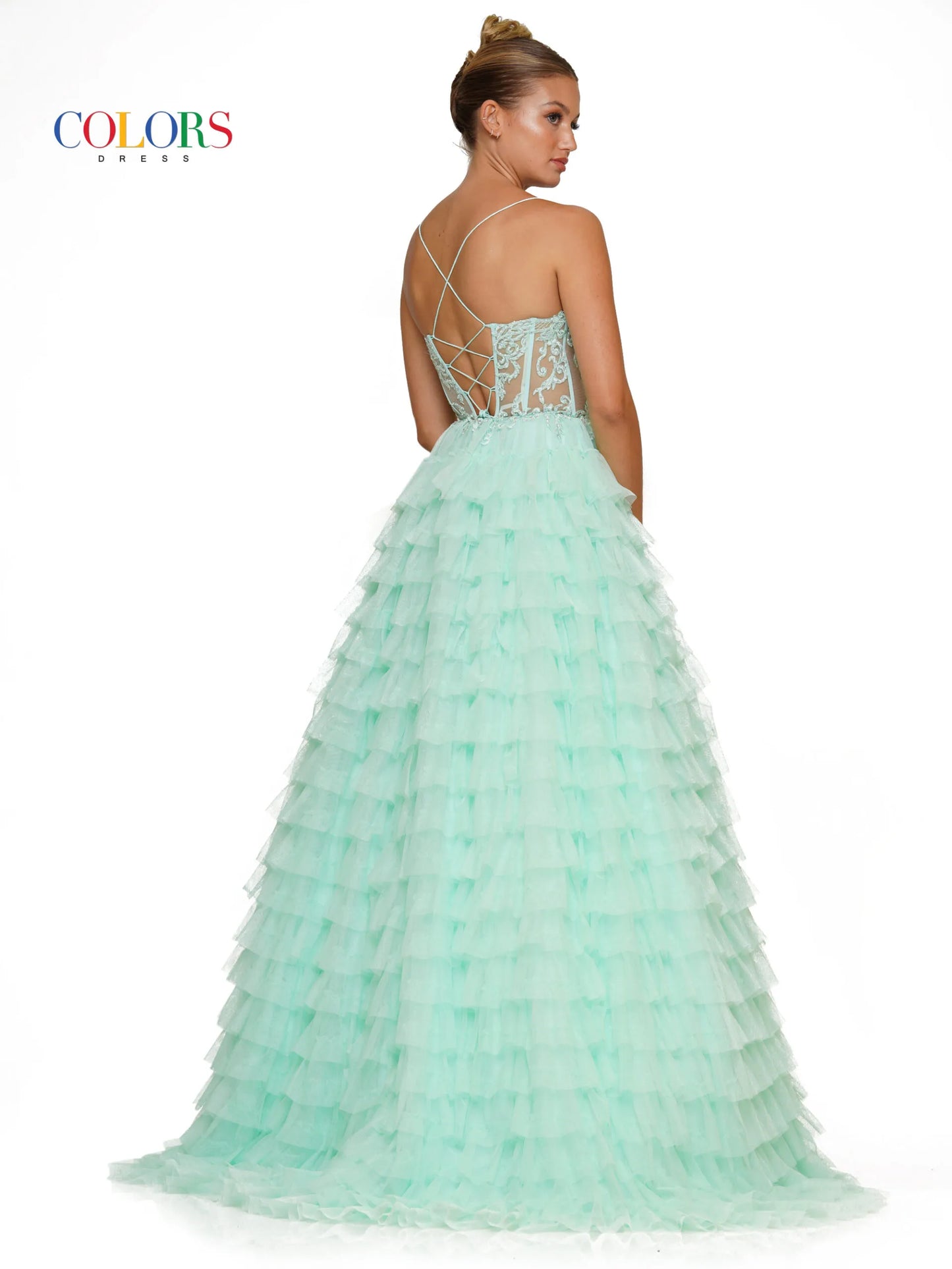 Colors Dress 3219 is a formal gown featuring a long sheer lace embellished v neck corset with ruffled layers and an elegant ball gown skirt. Embellished details add a luxurious touch to the design, making it perfect for proms and special occasions. Sizes: 2-24 Colors: Black, Light Blue, Mint, Pink