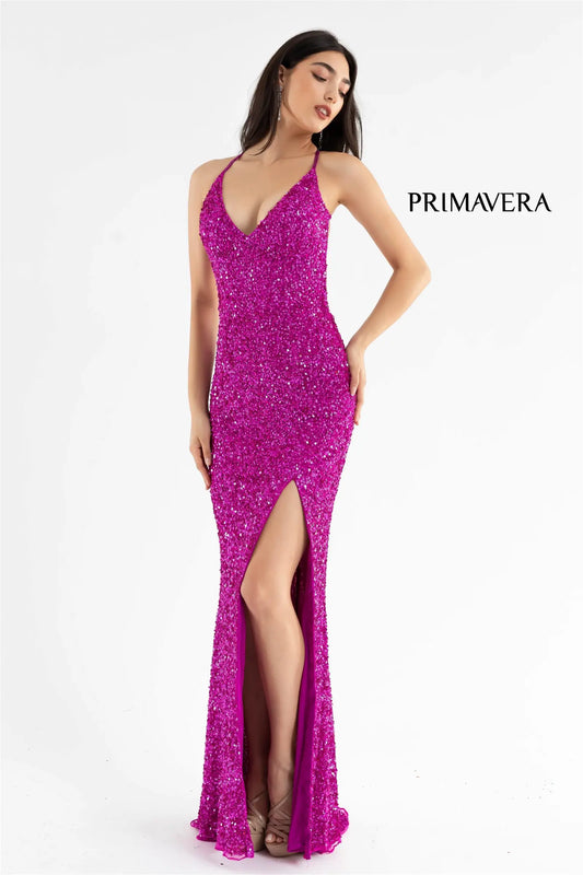 Primavera Couture 3291 Exclusive Prom Dresses. This long prom dress is embellished throughout with shimmering sequins. This impressive gown showcases a v neckline, thin beaded straps and crisscrossed straps in the open back. The long slim skirt has a sultry high side front slit.