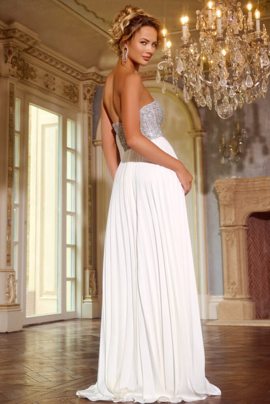 This stunning Jovani 42638 prom dress features a long pleated A-line silhouette, crystal bodice, and strapless slit. Perfect for prom or pageants, this gown will make a statement with its elegance and sparkle. The fitted bodice will accentuate your figure, while the flowing skirt adds a touch of glamour. The Beaded A-Line Strapless Gown 42638 epitomizes elegance with its stunning features. This gown is designed with intricate beading that graces the surface, adding a touch of sophistication to its majestic