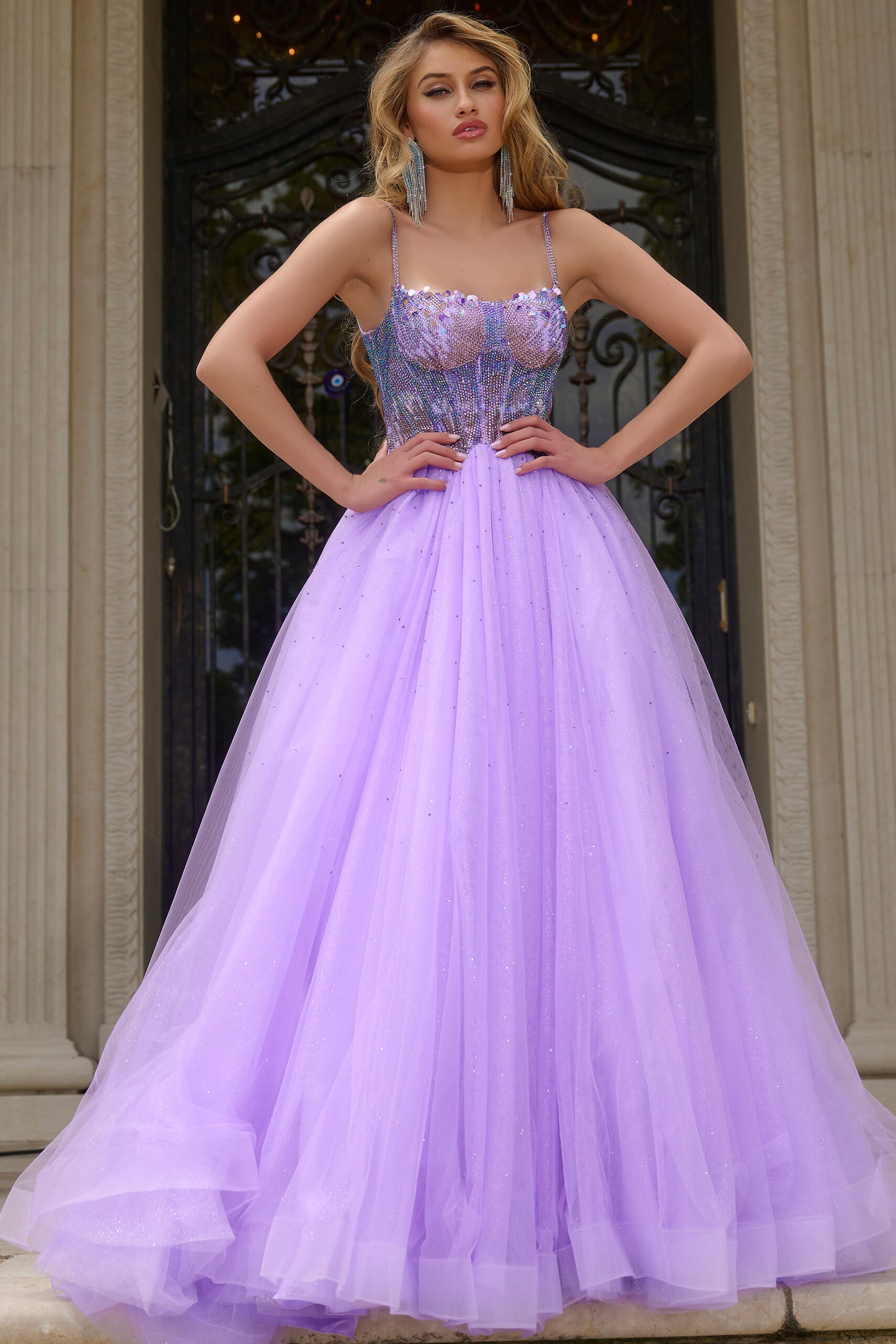 Indulge in luxury with the Jovani 44511 prom dress. Dazzling crystal bodice, A-line silhouette and shimmering sequins create a glamorous look. The scoop neck adds an elegant touch while the tulle and formal design elevate the style. Perfect for prom or pageants. Step into elegance with this exquisite ball gown, featuring a fitted beaded corset bodice that shimmers with intricate details.