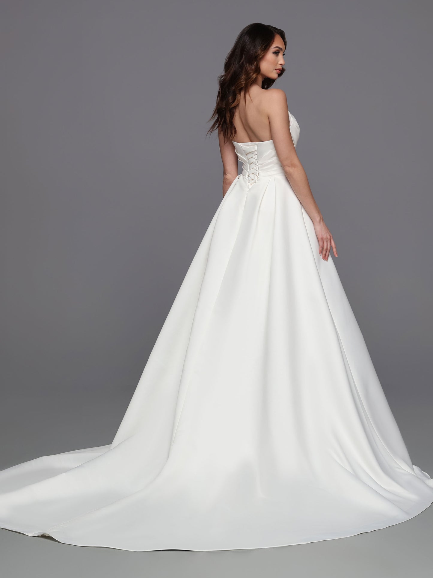 This stunning gown from Davinci Bridal is made from luxe satin and features a strapless faux-wrap bodice with a corset back and a slit maxi skirt for a modern, romantic look. The 50715 is perfect for a bride who wants a timeless style for her special day. Sizes: 2-20 Colors: Ivory