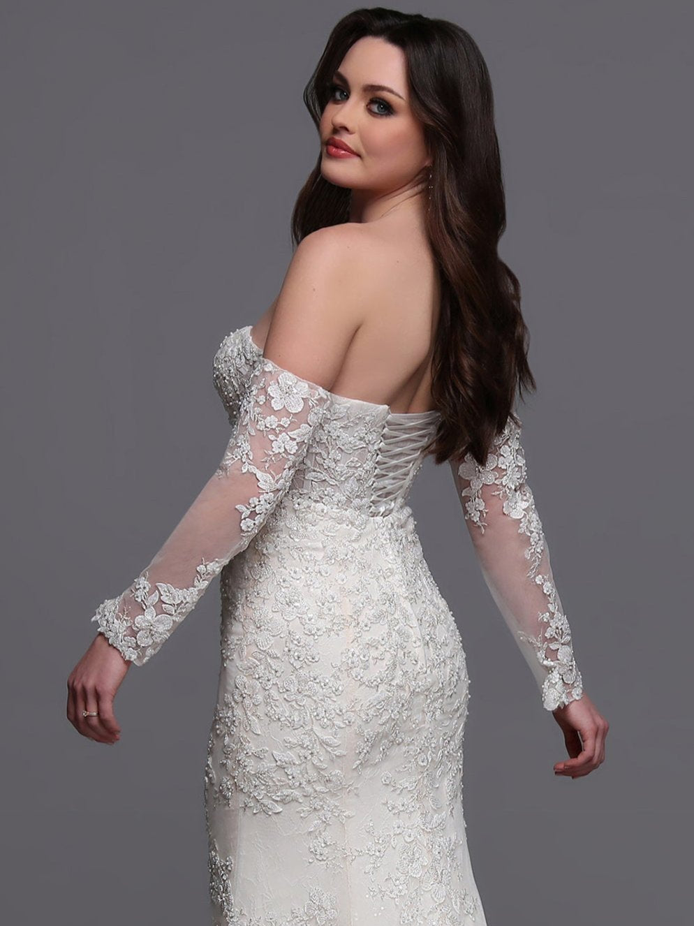 Indulge in elegance on your special day with the Davinci Bridal 50881 wedding dress. Flowing lace and intricate beading adorn the off the shoulder long-sleeves and corset back gown, leading into a stunning train. This mermaid-style dress is perfect for the modern bride who wants to make a statement. sequin shimmer
