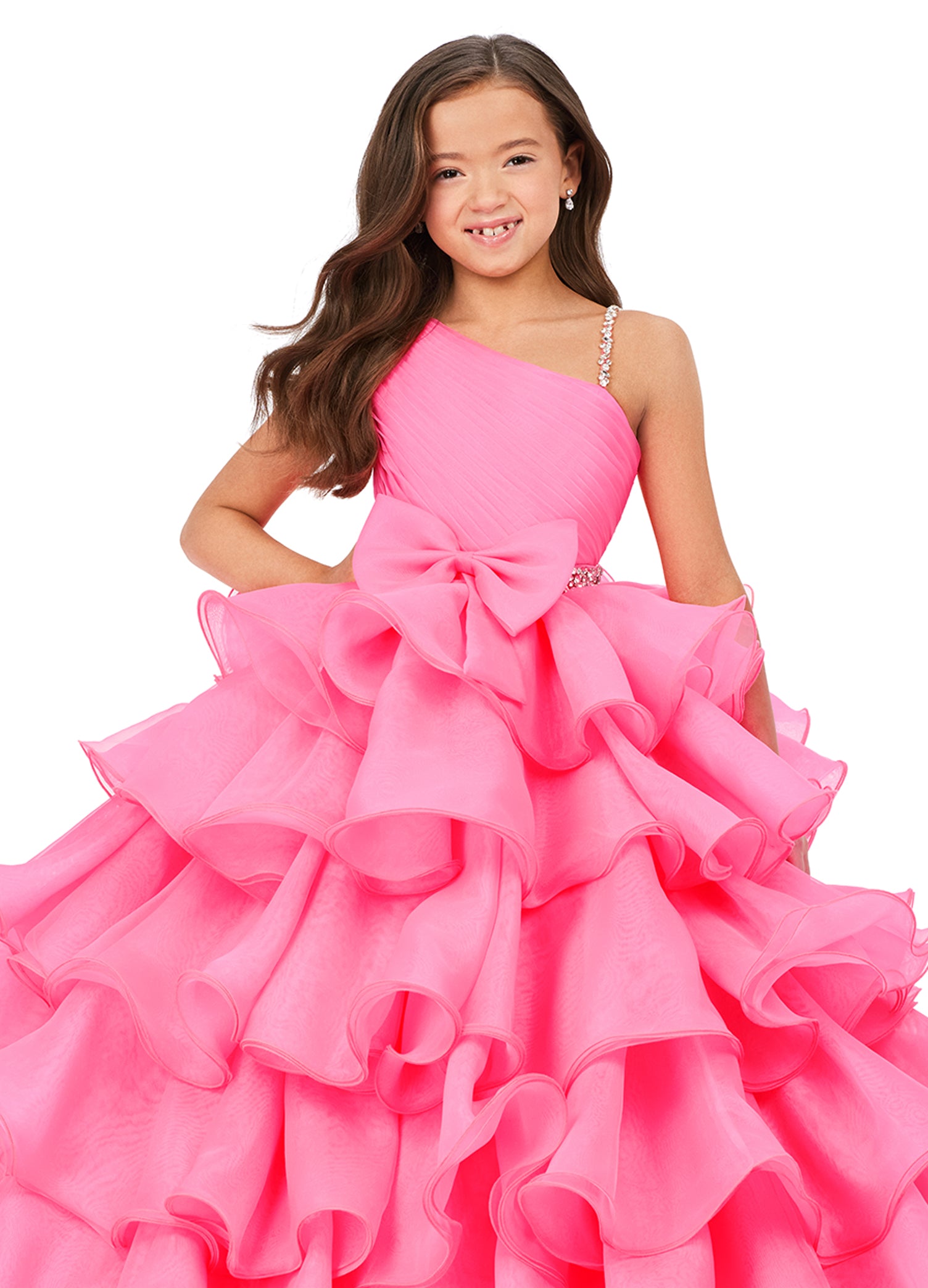 This Ashley Lauren Kids 8217 Long Ruffle Layer Girls Pageant Ballgown Bow Crystal Belt Gown is perfect for any special occasion! Elegantly crafted with an organza ball gown silhouette and one shoulder bustier, this dress also features beaded details along the waist line  and luxurious ruffles throughout the skirt. The waistband and shoulder strap are both beaded for added glam. One shoulder  Sizes: 4-16  Colors: Hot Pink, Aqua, Ivory
