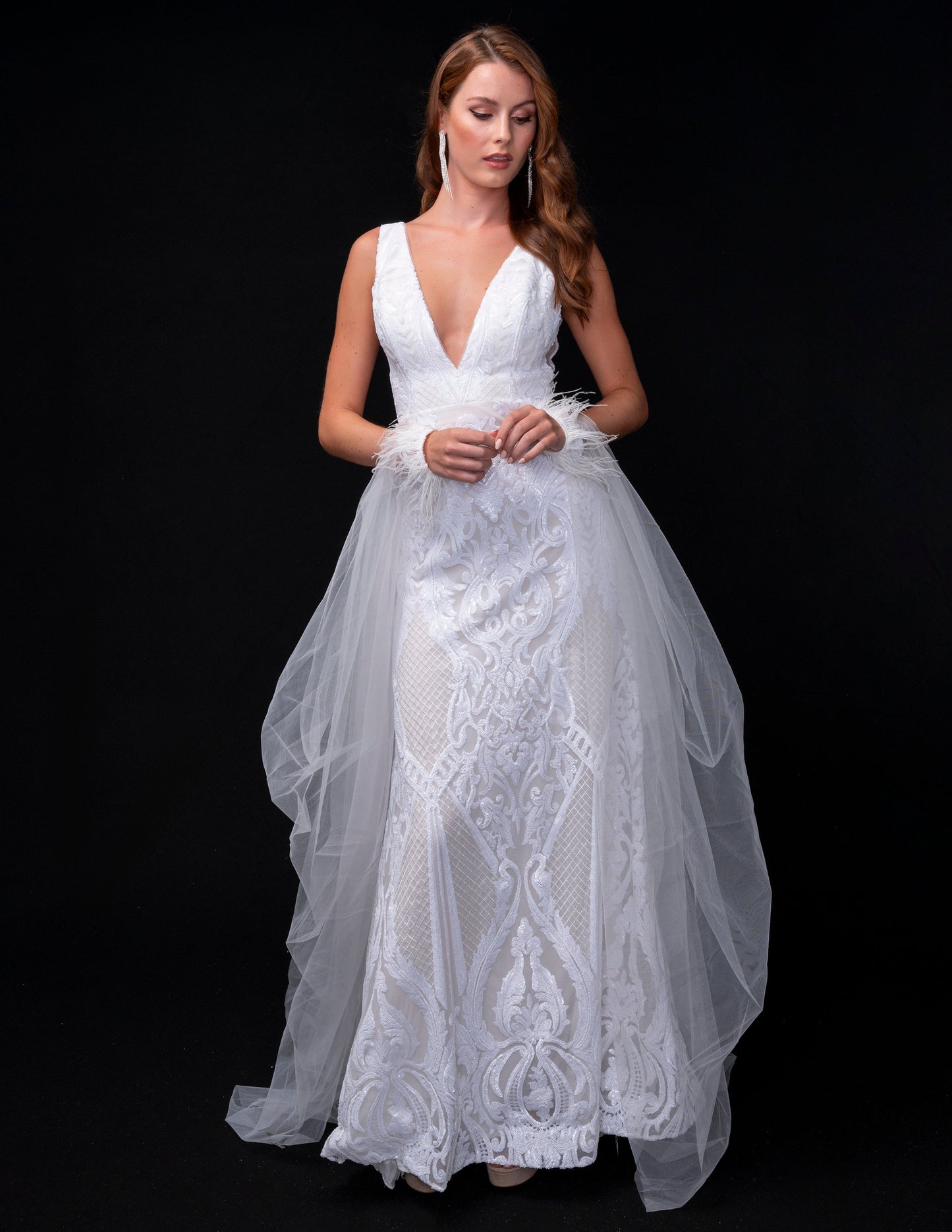 <p data-mce-fragment="1">This stunning Nina Canacci 8224 long, fitted pageant dress features a dazzling sequin design and a detachable tulle overskirt with a feather cuff. The elegant V-neckline adds a touch of sophistication to this show-stopping gown. Perfect for any formal event or pageant, this dress is sure to make a statement.</p> <p data-mce-fragment="1"> </p>