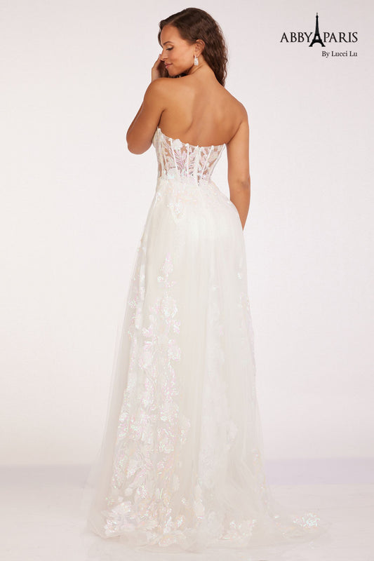 Impress in this Abby Paris 90229 Sheer Corset Sequin Prom Dress. The sheer corset accentuates your figure while the overskirt adds a touch of elegance. Sparkling sequins and a thigh-high slit make this the perfect pageant gown. Stand out with 100% confidence and sophistication. Size: 8 Color: White