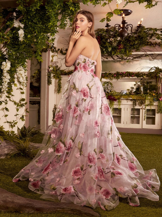 Andrea & Leo Couture A1035 Portrait of a Rose Printed Organza DressAndrea & Leo Couture A1035 Welcome to the fairytale world of magic and enchantment in this breathtaking A-line gown. This best selling gown is crafted from luxe Organza fabric, showing off an array of dimensional floral appliques and pink rose print. The strapless bodice features a sheer corset design, flaunting an ethereal blushing pink hue beneath a flourish of intricate roses and petals along the body. And