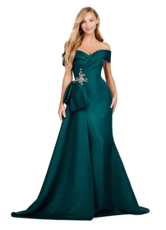 This Ashley Lauren 11425 Long Evening Dress is the perfect choice for any formal occasion. The off-shoulder design adds a touch of elegance, while the fitted satin fabric hugs your figure for a flattering silhouette. The overskirt adds a dramatic flare, making you feel like a pageant queen. Elevate your style with this versatile and stunning dress. An elegant off the shoulder neckline drapes the shoulders in elegant evening gown. The look is complete with beaded details and a side overskirt.