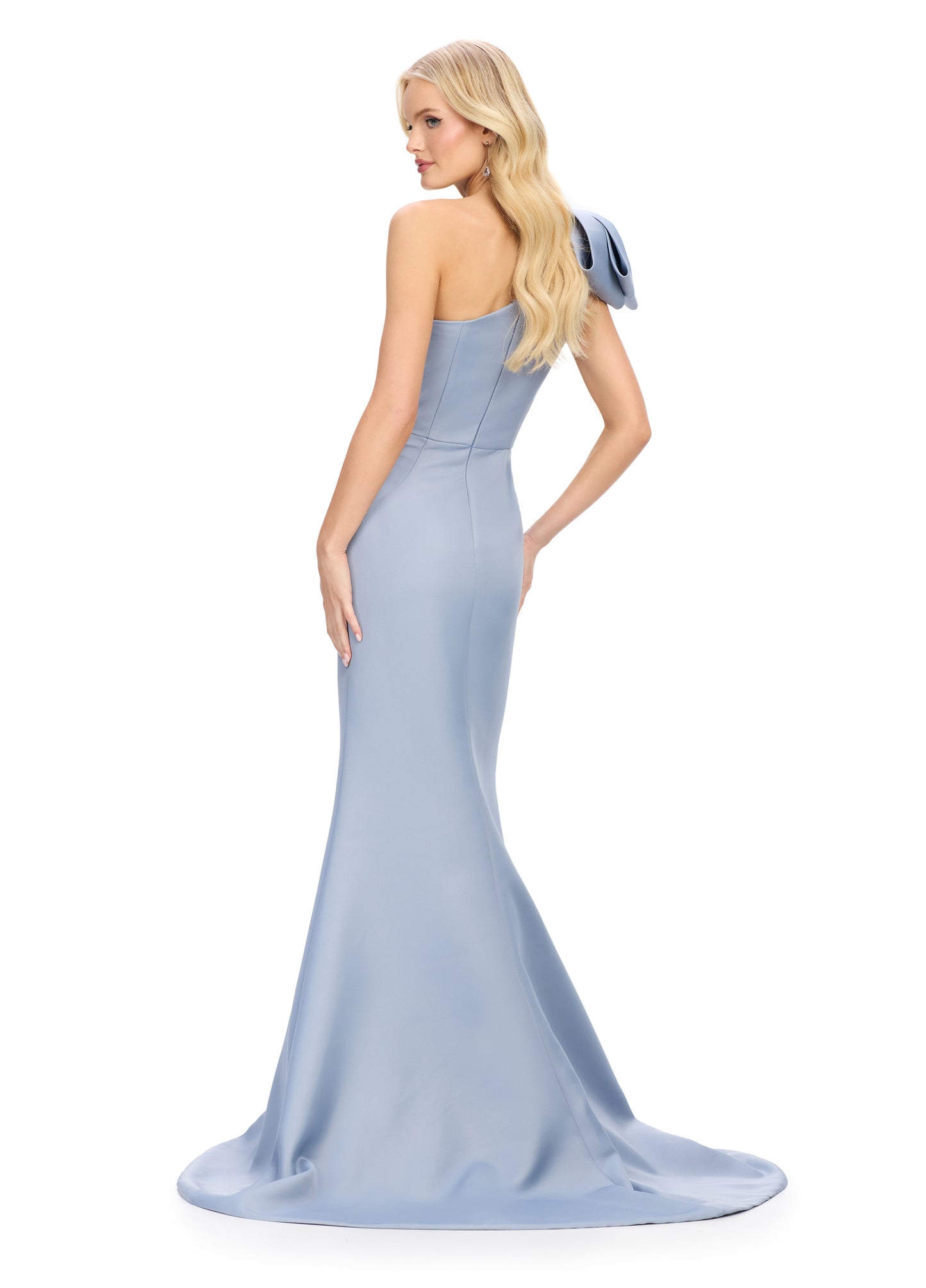 This Ashley Lauren 11759 satin evening gown combines elegance with modern details. The one shoulder design and bow add a touch of sophistication, while the ruched waist and short slit provide a flattering fit and added comfort. Perfect for any special occasion, this gown is sure to make you look and feel stunning.
