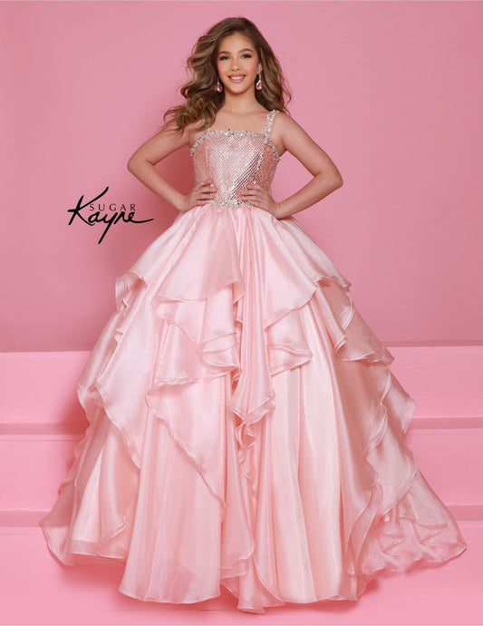 Step onto the pageant stage with confidence in the Sugar Kayne C383 Girls Pageant Dress. This stunning ballgown features a crystal bodice that will shimmer and shine under the lights, while the ruffle detail adds a touch of playful elegance. The layered skirt adds volume and movement, making you the star of the show. Make a dramatic statement at your next pageant with this stunning diamond mesh dress. The ruffled shimmer organza skirt completes the look, offering a perfect blend of elegance and flair.
Size