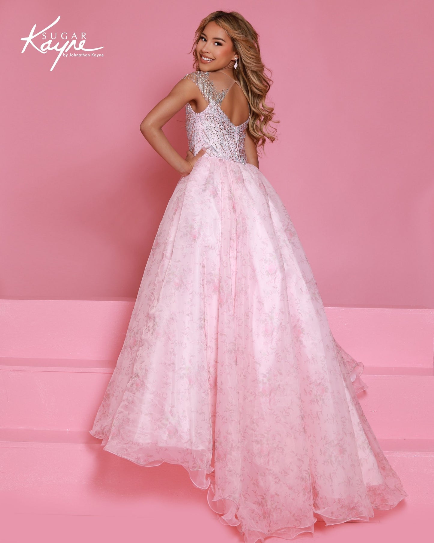Designer: Sugar Kayne — Style C406
Sugar Kayne style C406 is a classic girls pageant dress with layered organza and a smooth satin lining for beautiful volume and shine. The full skirt and refined bodice give this gown timeless pageant appeal, making it ideal for everything from local titles to national stages.
Sizes: 2–16
Colors: Blush, Blue