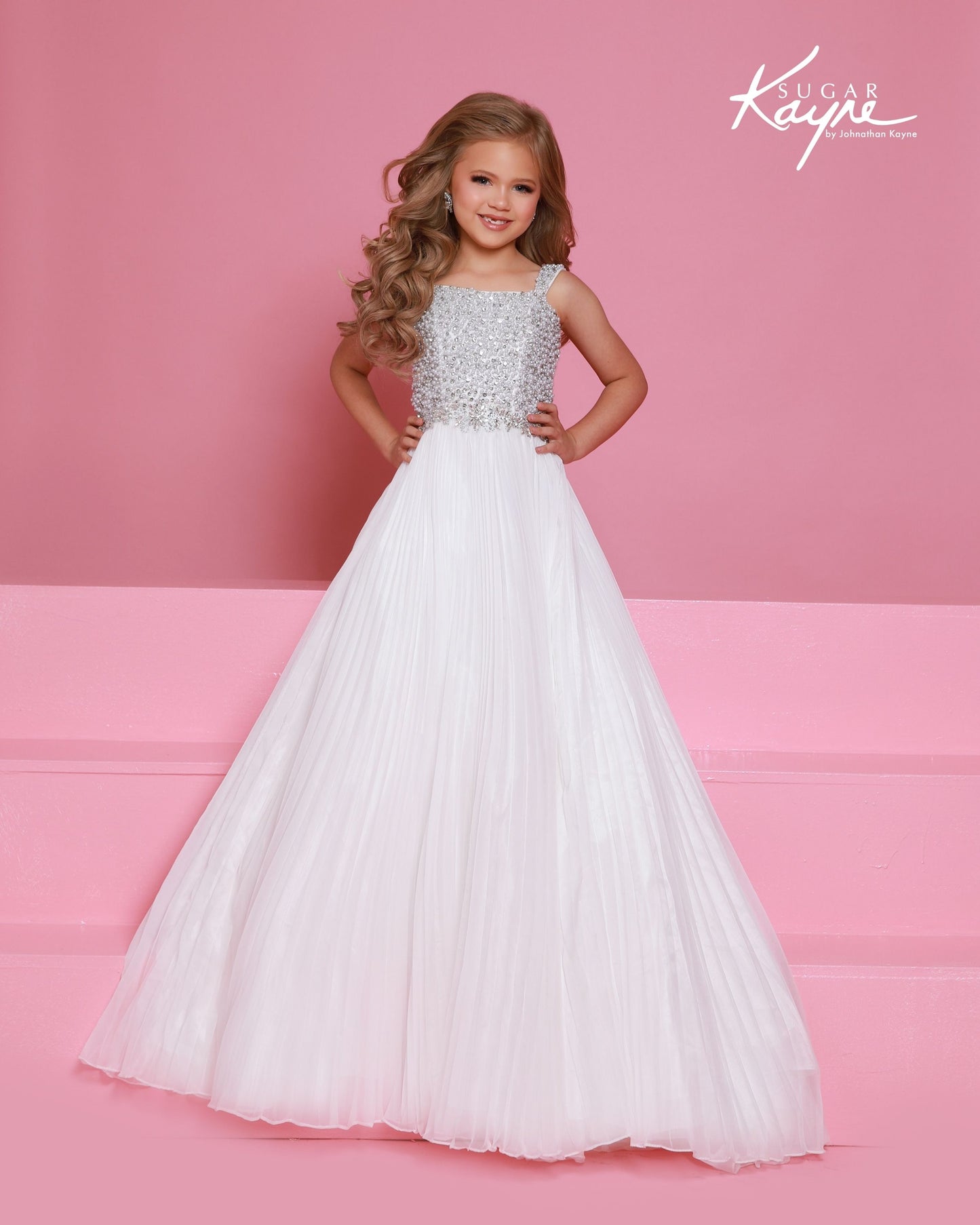 Designer: Sugar Kayne — Style C408
This lightweight Sugar Kayne girls pageant dress, style C408, showcases flowing chiffon over a satin lining for effortless drape and motion. The look is soft, feminine, and comfortable, giving her a confident presence from interview to evening wear on the pageant stage.
Sizes: 2–16
Colors: Hot Pink, Turquoise, White