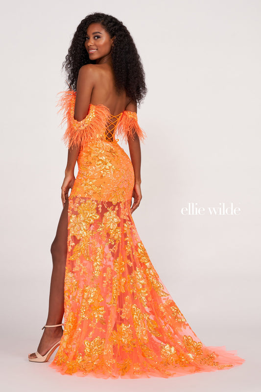 The Ellie Wilde EW34034 is a glamorous formal gown featuring an off-the-shoulder neckline, corset bodice, and a full-length sheer sequin skirt with a side slit. Festooned with a beautiful feather trim, this dress is sure to make a statement. Sizes: 00-16 Colors: ORANGE, ROYAL BLUE, LILAC, HOT PINK, SAPPHIRE, SKY BLUE, EMERALD, PURPLE RAIN