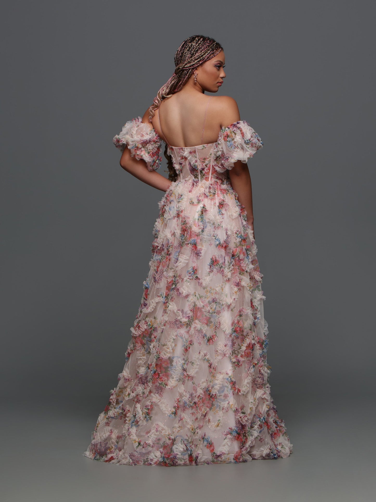 Experience elegance and grace with the Davinci F145 Floral Print Prom Dress. The stunning puff sleeves and A-line silhouette enhance your natural beauty while the sheer corset and shimmering pleats create a dreamy and ethereal look.