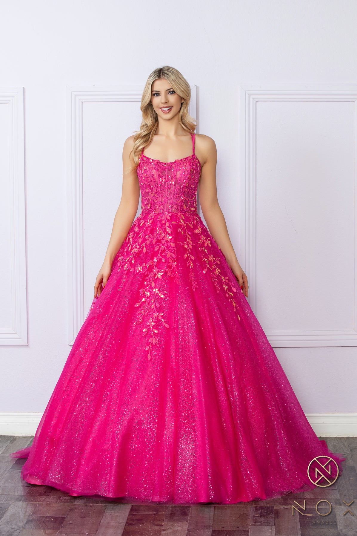 Elevate your prom night look with the Nox Anabel H1271 dress. This elegant A-line gown features a stunning shimmering tulle design with a sheer sequin corset and a flattering scoop neck. Perfect for making a statement with a touch of glamour. Sizes: 00-16 Colors: Green, Fuchsia, Lavender