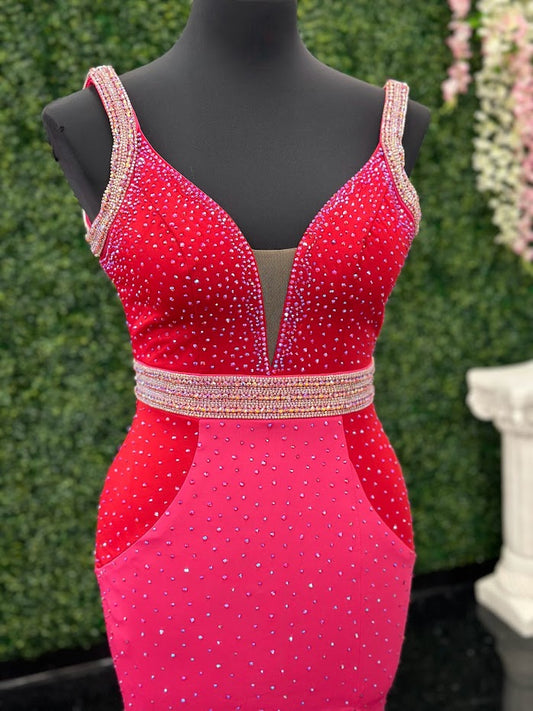 The Johnathan Kayne 2628 is a glamorous pageant dress, crafted from fitted scuba for a sleek and form-flattering effect. The gown features a crystal accented waist line, shoulder straps and v neckline with scattered crystals and glittering accents, making it perfect for special occasions. With its comfortable fit and elegant design, this size 4 dress adds sparkle to any ensemble. Color Block Combo. *Theses are ONE OF A KIND! Size: 4 Color: Red/Fuchsia