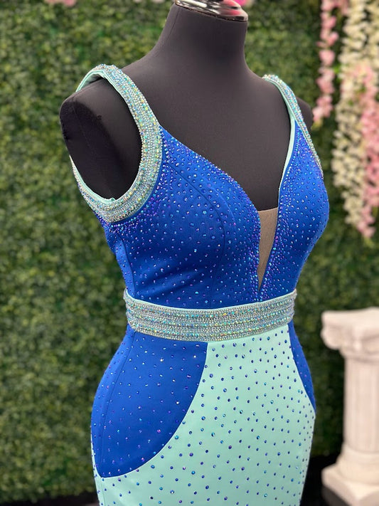 The Johnathan Kayne 2628 is a glamorous pageant dress, crafted from fitted scuba for a sleek and form-flattering effect. The gown features a crystal accented waist line, shoulder straps and v neckline with scattered crystals and glittering accents, making it perfect for special occasions. With its comfortable fit and elegant design, this size 4 dress adds sparkle to any ensemble. Color Block Combo. *Theses are ONE OF A KIND! Size: 4 Color: Royal/Aqua