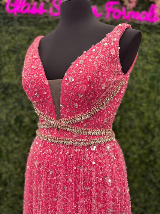 Look stunning in the Johnathan Kayne 5400 dress. This formal gown features a V-neckline, bead and sequin embellishments, and crystal accents all over for a truly show-stopping look. The A-line silhouette will flatter all body types and ensure you remain comfortable throughout the evening. *ONE OF A KIND Size: 4 Color: Pink