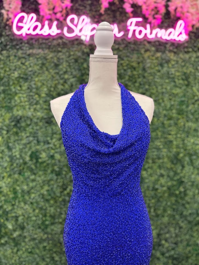 Johnathan Kayne 2728 is a size 4 cowl neck formal gown crafted with Custom Liquid Beading. The halter neck closure makes for a beautiful and stylish silhouette with a royal finish. Perfect for your next event! ** One of a kind Custom Size: 4 Color: Royal