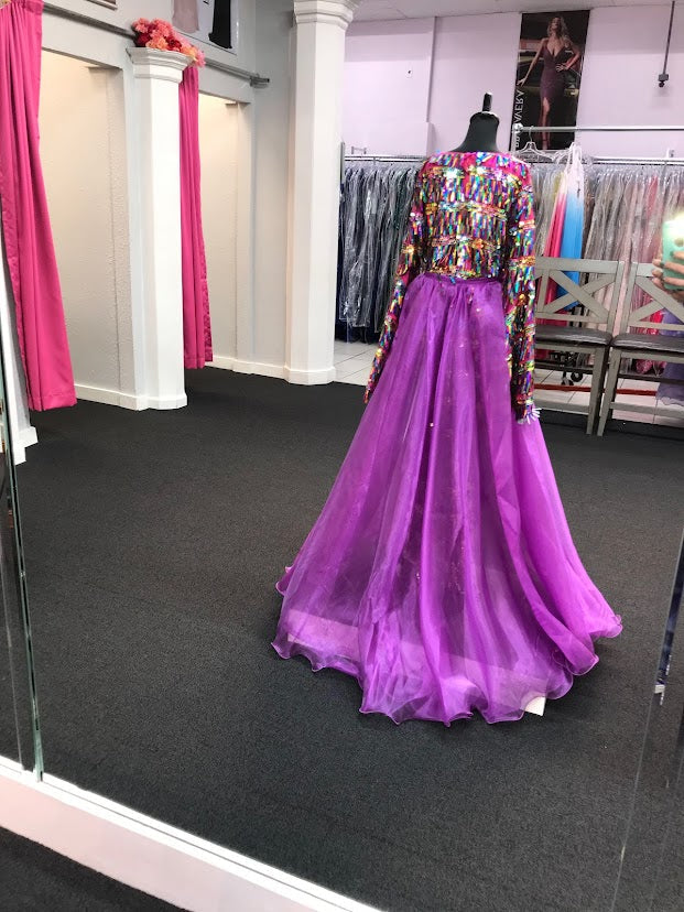 Marc Defang 5010L Long Sequin Bell Sleeve Jumpsuit Overskirt Girls Fun Fashion v This Fun Fashion jumpsuit comes with detachable overskirt is included in the price Fully iridescent multicolor beaded romper With soft knitted inner lining for comfort Side zipper Floor length overskirt adds fun to walk. Available Sizes: 4-14 Available Colors: Purple, AB White If Not in stock please allow 30 days for delivery