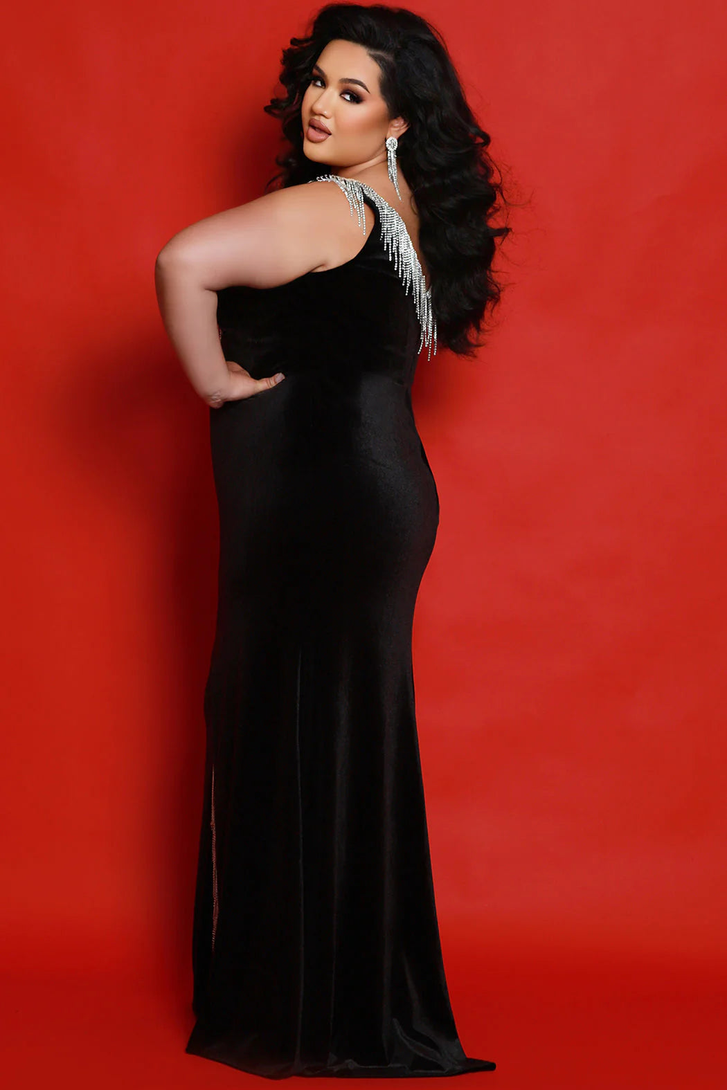 Sydneys Closet JK2412 dress adds effortless elegance to your formal wardrobe. Crafted from luxurious velvet with a V-neck design, its fitted silhouette is enhanced with a slit and trimmed with fringe detailing. The long length provides added coverage for a timelessly sophisticated look. Plus size fit. Rev up your style and hit the stage or dance floor in the Speedway plus-size velvet evening gown. Fitted silhouette accentuates your fabulous curvy figure.