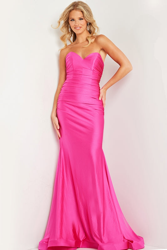 This stunning Jovani JVN37006 dress features a long ruched mermaid silhouette, perfect for any formal occasion. Made with high-quality jersey fabric, its strapless design exudes effortless elegance. Elevate your prom night or special event with this timeless and figure-flattering piece. Sizes: 00-24 Colors: Black, Fuchsia