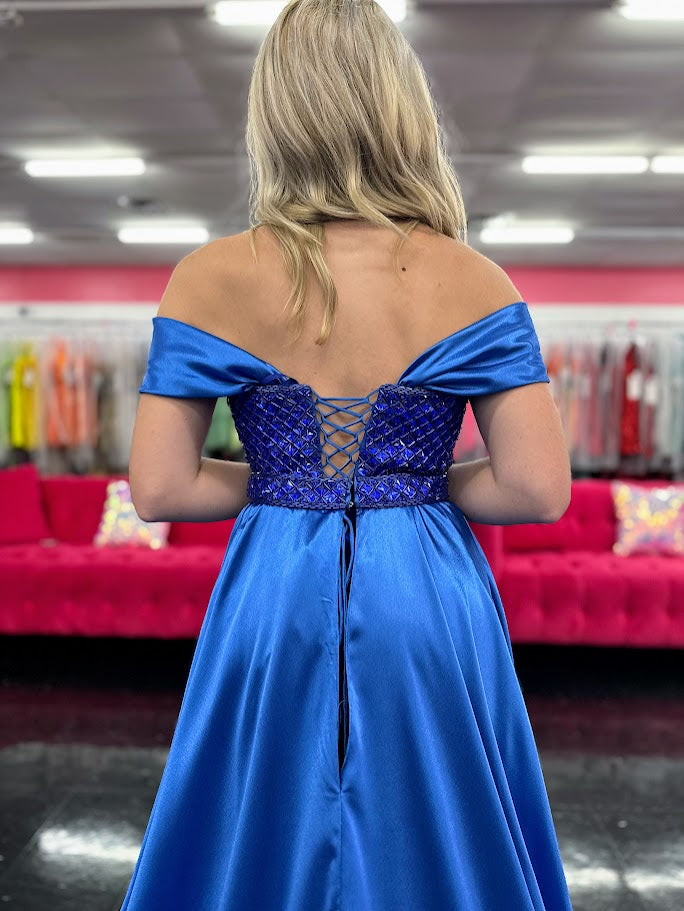 This Johnathan Kayne 2725 gown combines luxurious velvet with elegant satin details for a striking pageant look. The fitted silhouette features a straight neckline and a crystal-beaded bodice that adds refined sparkle. Detachable off-the-shoulder satin sleeves offer versatile styling, while the long satin overskirt and corset lace-up back with crystal tassels enhance both drama and fit. A tasteful slit completes this sophisticated design, perfect for making a memorable impression.
Size: 4
Color: Roy