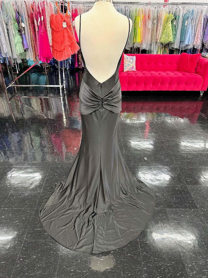 Indulge in the ultimate luxury with the Jovani D5054 Fitted backless satin prom dress. Featuring a crystal bow bodice and formal evening gown design, this dress exudes sophistication and elegance. The fitted silhouette accentuates your curves while the backless design adds a touch of sensuality. Make a statement at your next event with this exclusive piece. Experience elegance in this captivating gown featuring a floor-length silhouette that gracefully glides with every step. The dress boasts an illusion sw