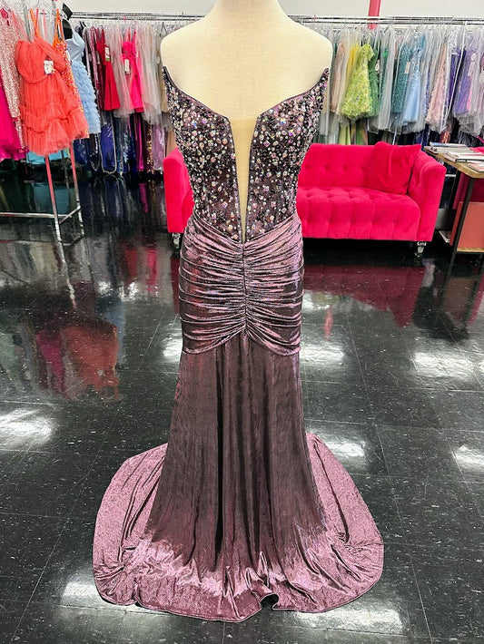 Experience true radiance and allure in our Jovani D5055 Long Ruched V Neck Shimmer Prom Dress. With a stunning V-neckline and shimmering fabric, this formal evening gown will make you stand out at any event. The ruched detailing adds a touch of sophistication, while the long silhouette elongates your figure. Elevate your wardrobe with this exclusive and luxurious piece.
Sizes: 12
Colors: Purple