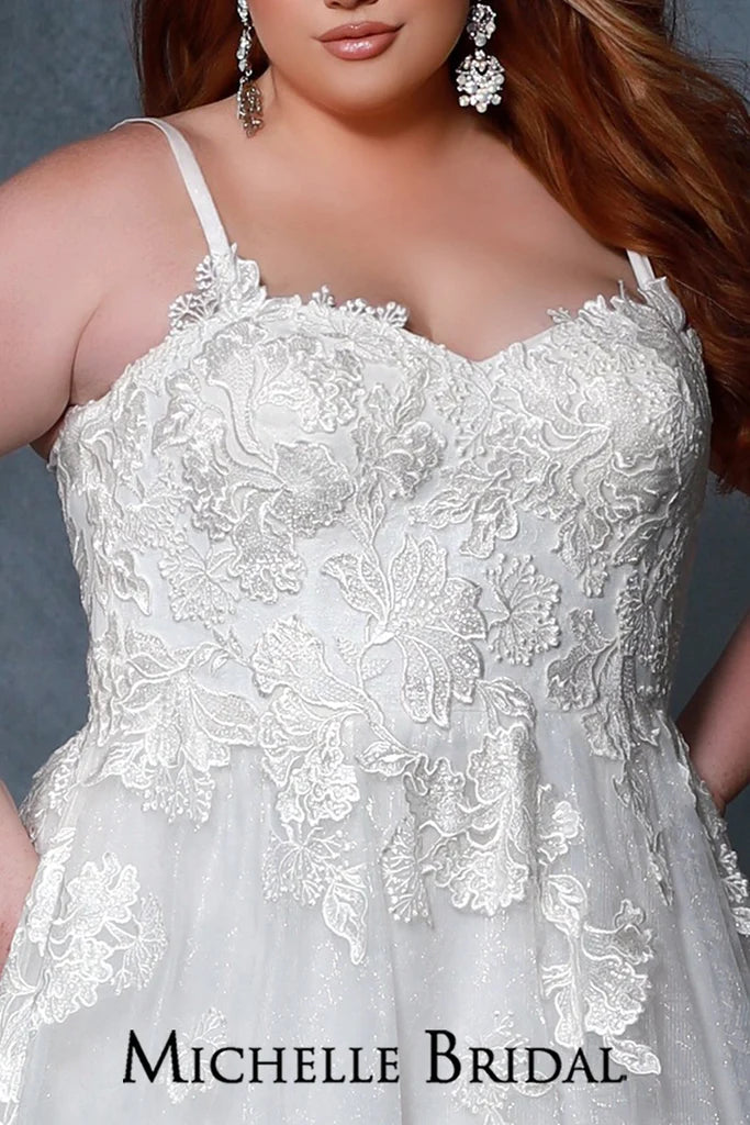 Michelle Bridal For Sydney's Closet MB2205 A-Line Silhouette Sweetheart Neckline Net Embossed With Floral Pattern Contemporary Dramatic Floral Appliques With Clear Sequins Plus Size "Fleur" Bridal Gown. Look your best on your special day with the Michelle Bridal For Sydney's Closet MB2205 Plus Size "Fleur" Bridal Gown. Featuring an A-Line silhouette with a sweetheart neckline, this net embossed gown is adorned with contemporary dramatic floral appliques and clear sequins for a truly memorable look.