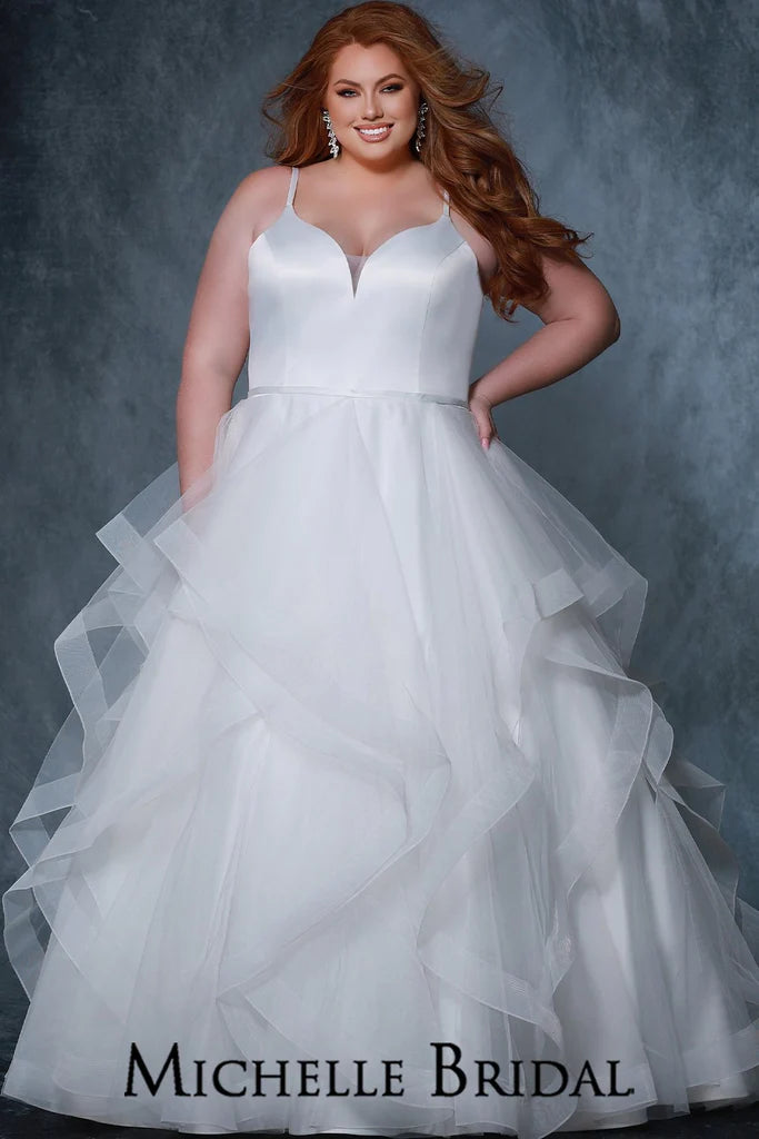 Michelle Bridal For Sydney's Closet MB2207 A-Line Silhouette Sweetheart Neckline Satin bodice Satin Straps And Belt Soft Tulle Layered Tiers With Horsehair Hem Plus Size "Jolie" Bridal Gown. Be the vision of beauty in this Michelle Bridal for Sydney’s Closet Plus Size “Jolie” Bridal Gown. It features a classic a-line silhouette with sweetheart neckline, satin bodice and straps, and a belt. The skirt consists of soft tulle layered tiers with a horsehair hem, creating an enchanting look. 