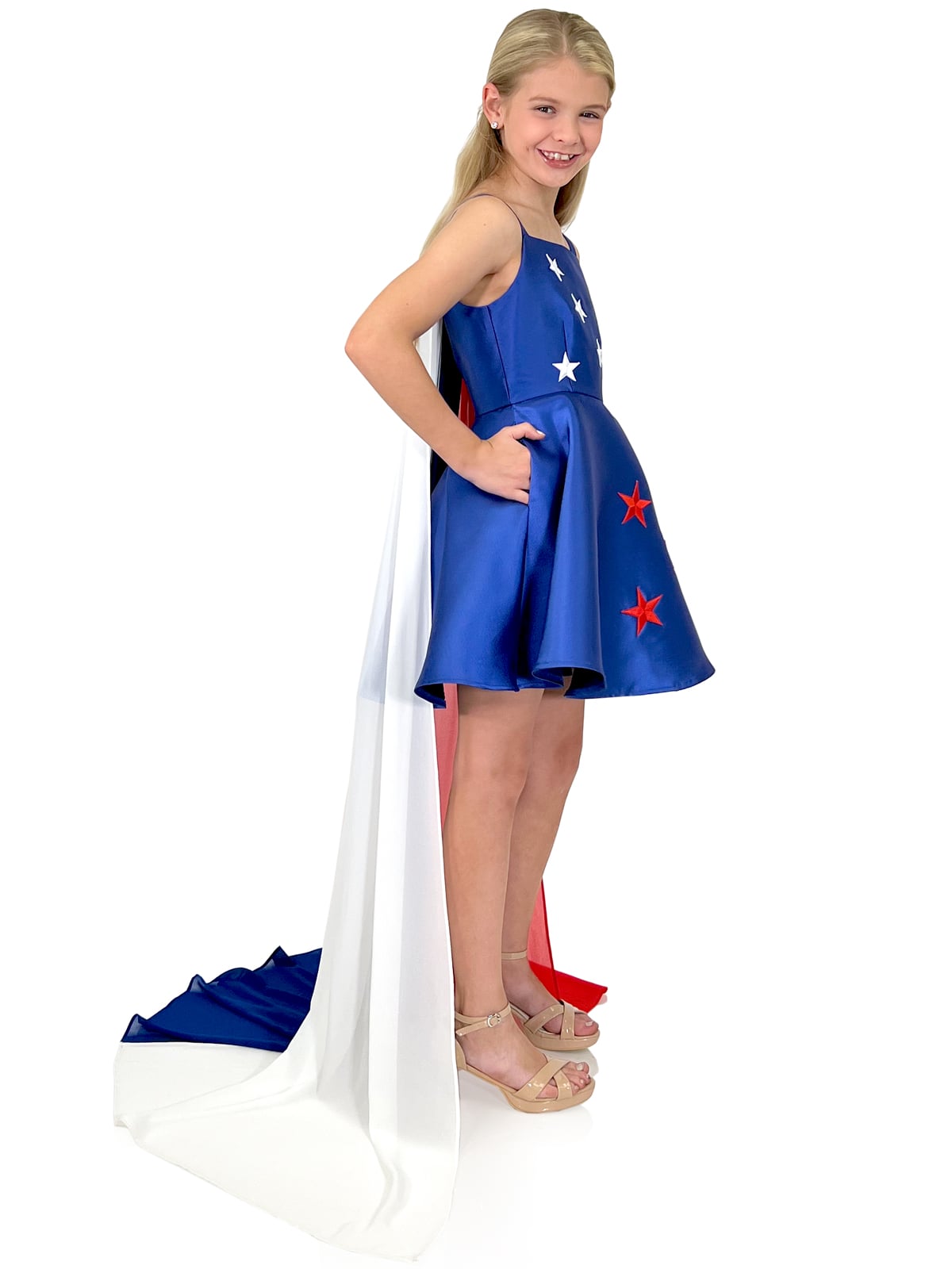 Marc Defang 5030 Red White & Blue Girls Pageant Fun Fashion Cape Detachable chiffon skirt/cape. Stars adorn he short a line dress. Perfect for Fun Fashion! Fourth of July - Independence Day Pageant Available Sizes: 4-14 Colors: Red/White/Blue