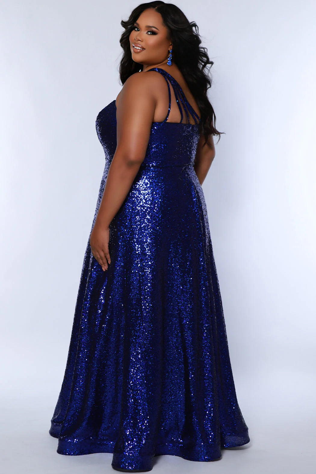 Elevate your look in Sydneys Closet SC7389 Long Prom Dress. This plus size sequin gown features an off-shoulder neckline, A-line silhouette, and pockets for added convenience. Perfect for formal occasions, this dress ensures you'll make a stunning entrance. Be the glamour Queen at Prom 2024 or any formal gala when you sparkle in our 1-shoulder sequin plus size evening dress. 