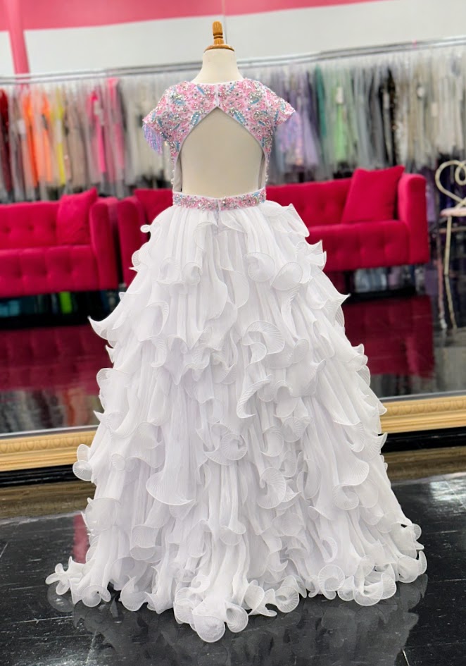 The Samantha Blake 1138 Long Pleated Girls Pageant Dress is a stunning showcase of beaded fringe and crystal embellishments. The Layered pleated Skirt design adds texture and dimension to the gown, making it a standout choice for any pageant.