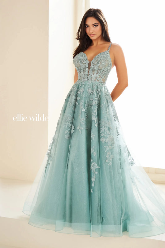 Be the star of the prom in the exquisite Ellie Wilde EW36015 Long Prom Dress. This stunning A-line gown features sheer lace and shimmering details, perfect for any formal occasion. With its beautiful design and comfortable fit, you'll feel confident and elegant all night long. Embrace your inner beauty and shine in this gorgeous ballgown.