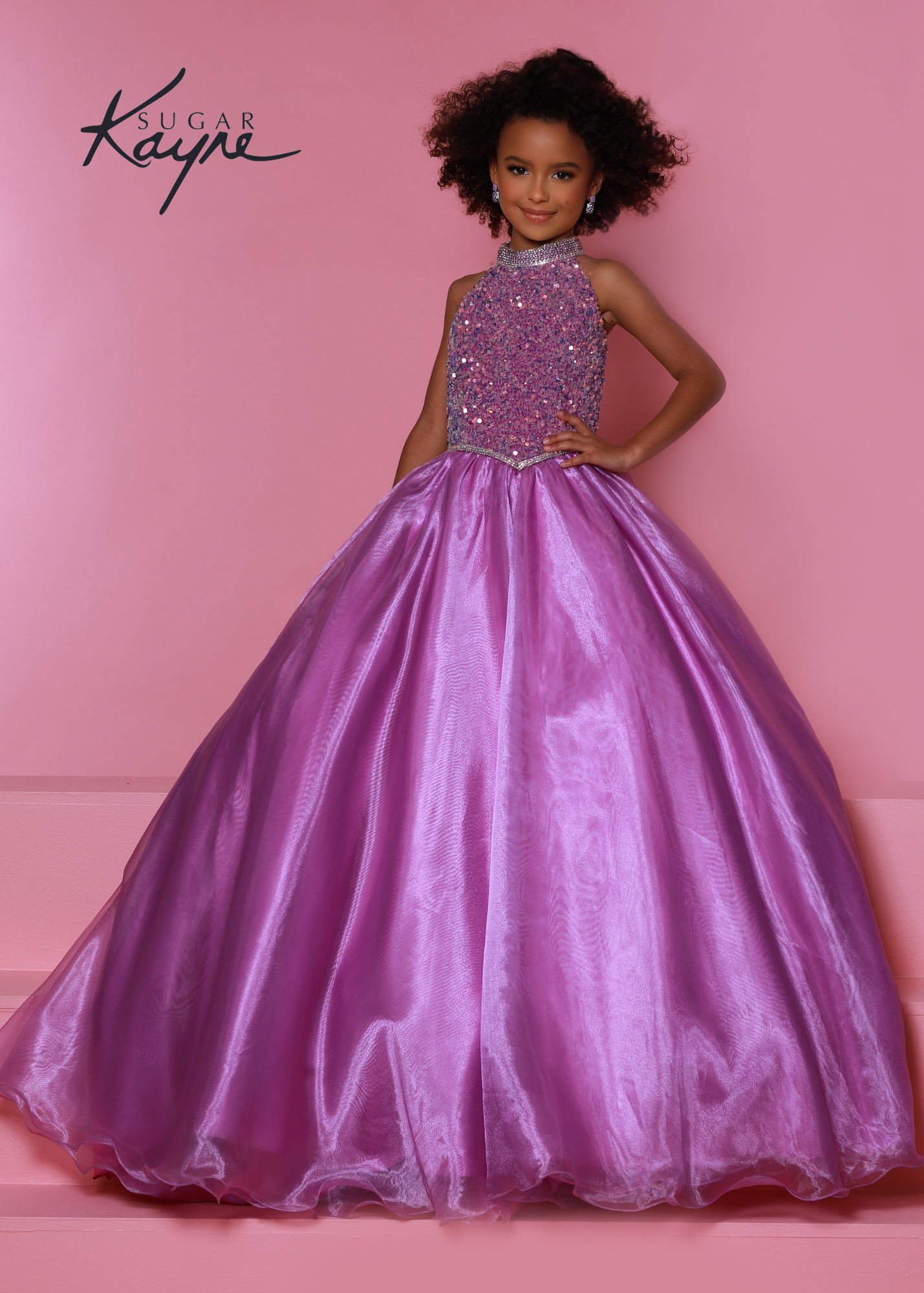 Sugar Kayne C302 sequin stretch velvet and organza ballgown features a stunning beaded halter with dropped waist and rhinestone trim and beaded strap back Available Sizes: 2-16 Available colors: Aqua, Cotton candy, Orchid, Powder Blue