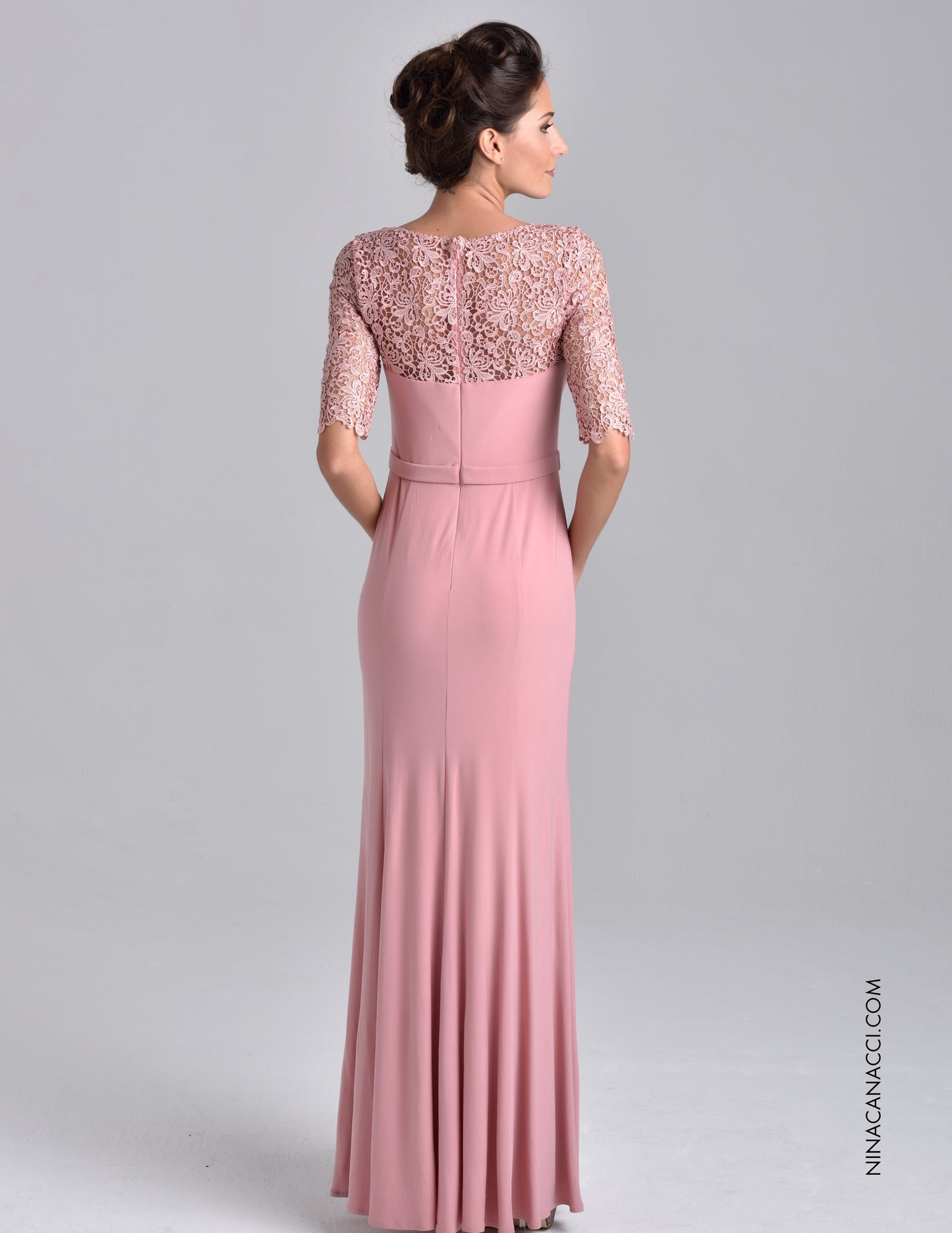 Nina Canacci M218 This stunning evening gown features a scoop neckline with three quarter length sleeves. Sheer lace wraps the top, glides down the center bodice and rounds the slim waist. Accenting the front side of the band are clustered beads that add sparkle and flair. The slim silhouette will showcase your best figure with the full length hem completes the impressive look. Available Sizes: 6, 8, 10 Available Colors: Taupe