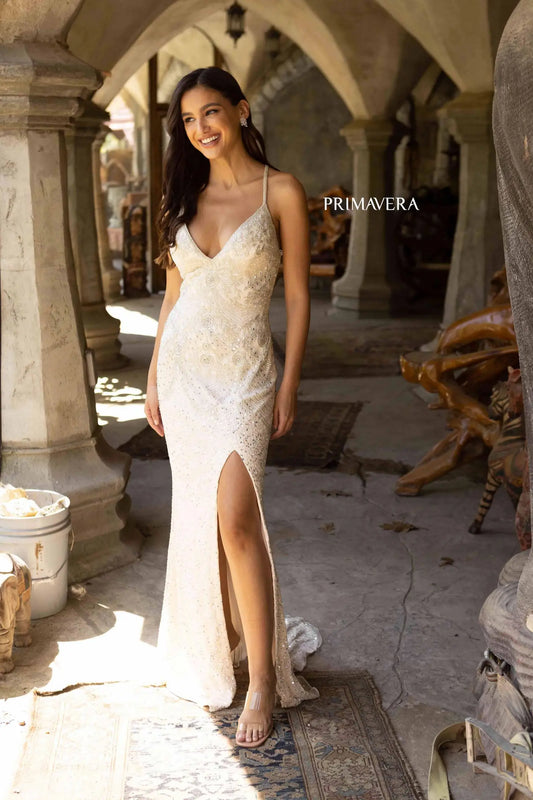 Primavera Couture 3909 Sequined Prom Dress Primavera Couture 3909 is a fully beaded dress with a V neckline and leg slit. It has criss cross straps in the open back. Perfect for prom or pageant. Sizes: 000-24 Colors: NUDE, PLATINUM, BLACK