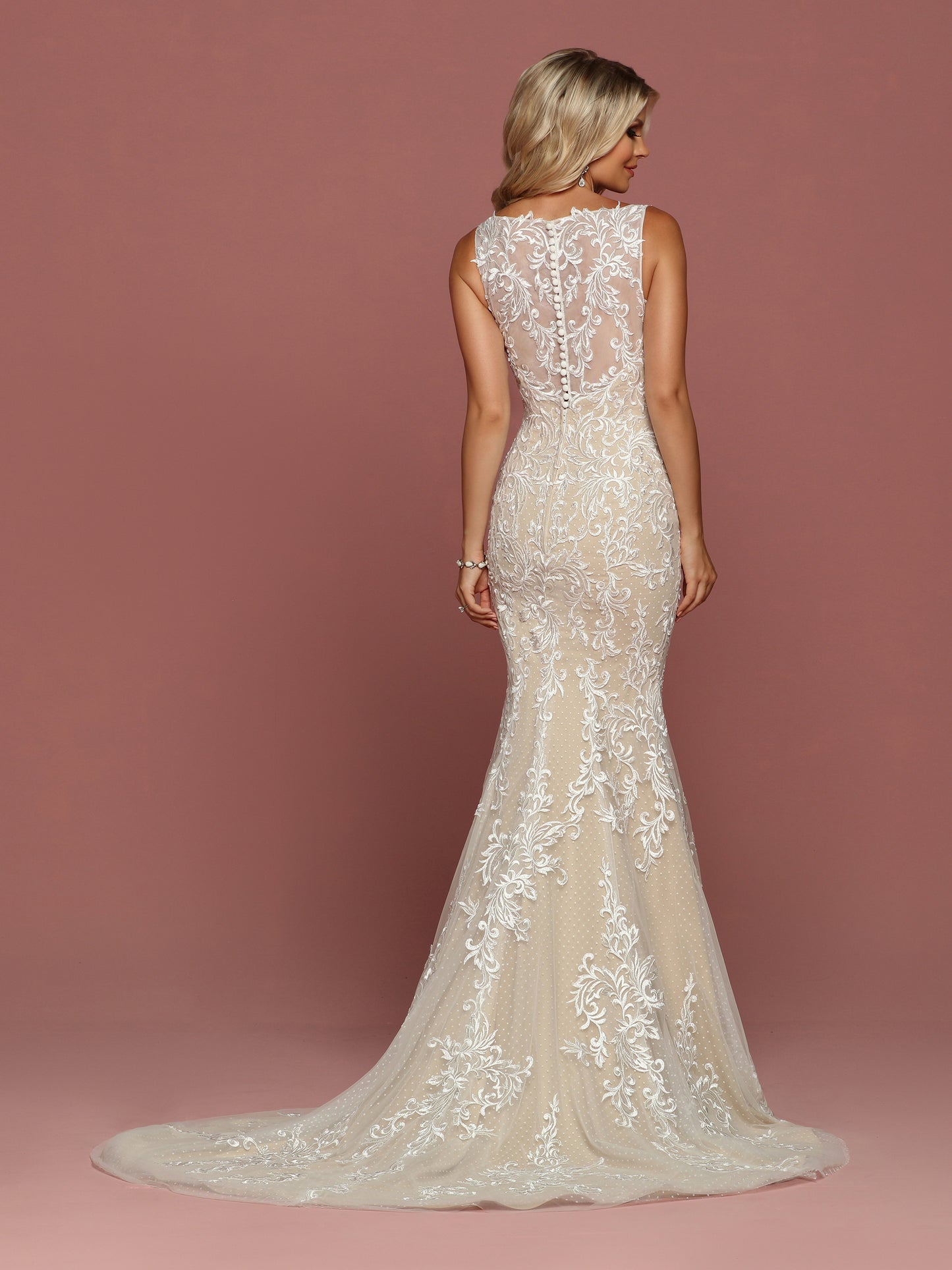 Davinci Bridal 50486 is a Fitted Mermaid Silhouette wedding dress. Featuring Point D' Esprit & Tulle. This Gown Has a V Neckline with Sheer lace straps leading to a sheer Illusion Lace back. Buttons line the back seam. Delicate lace covers this gown and cascades down into the trumpet skirt and train. Available for 1-2 Week Delivery!!! Available Sizes: 2,4,6,8,10,12,14,16,18,20 Available Colors: Ivory/Nude, Ivory/Ivory