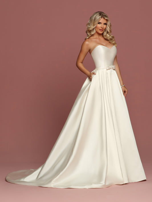 Davinci Bridal 50494 is a gorgeous Mikado Wedding Dress. Strapless Sweetheart neckline with a simple waist belt with bow. Full Pleated skirt has Pockets! Button line the entire back seam of the gown into the train. Available for 1-2 Week Delivery!!! Available Sizes: 2,4,6,8,10,12,14,16,18,20 Available Colors: Ivory