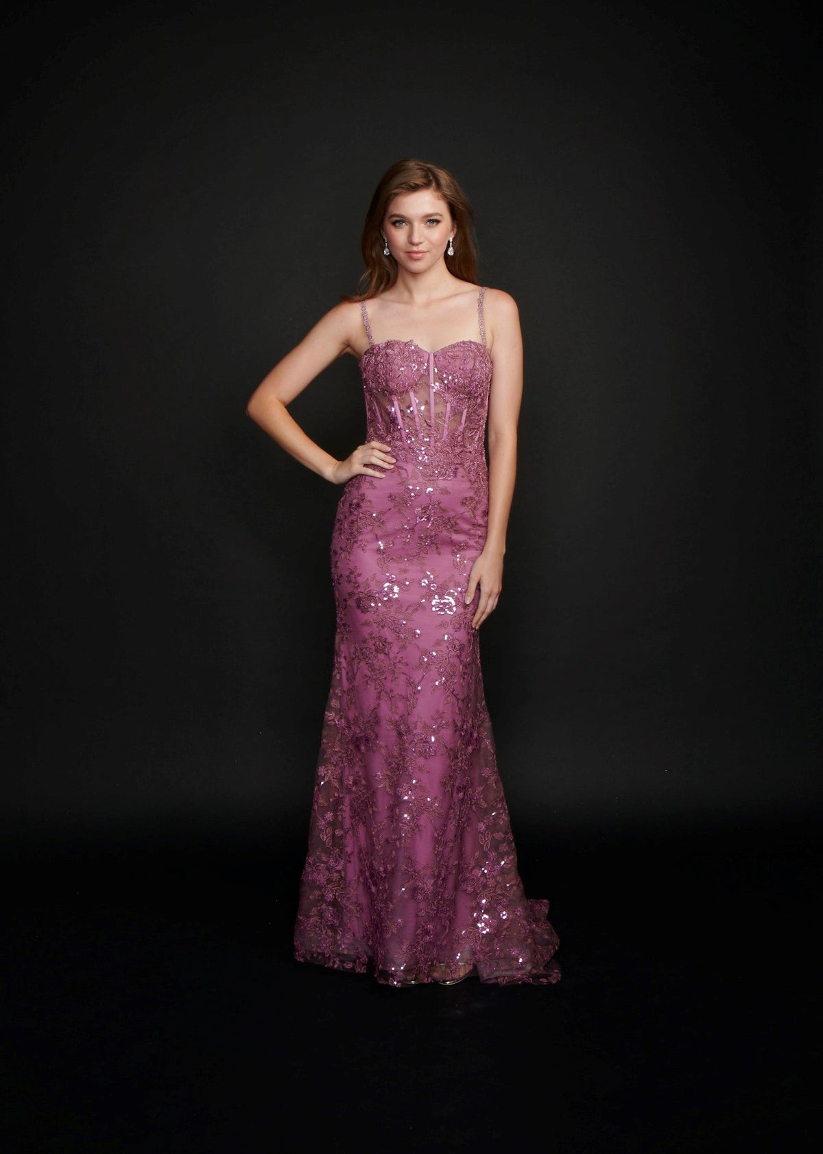 Nina Canacci 6556 Long sheer lace corset fitted bodice with a mermaid skirt and train. Embellished Prom Pageant Gown Available Size-0-12 Available Color- Ivory, Baby Blue, Raspberry (Mauve)