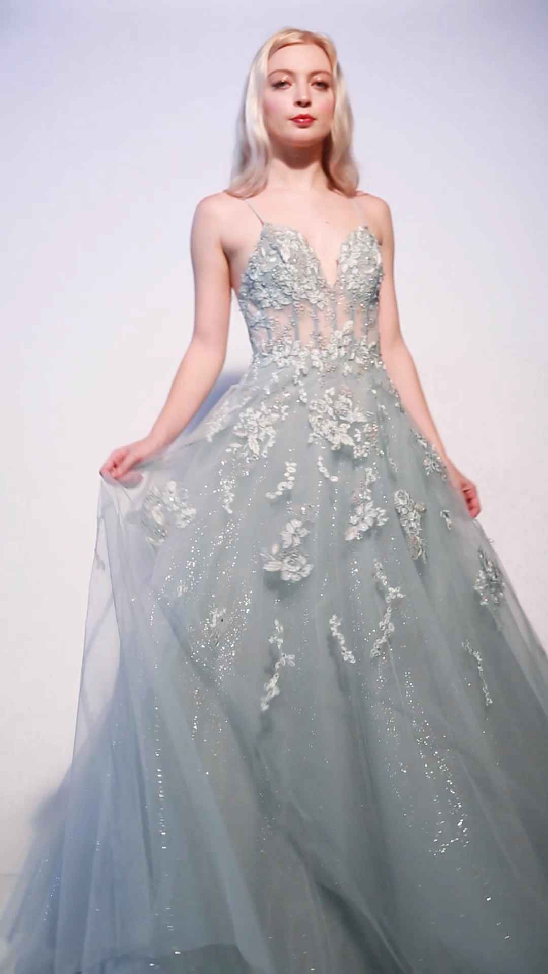 Andrea & Leo SOPHIA A0892 is an A Line Shimmering tulle Ballgown. This long Formal Dress Features a sheer bodice with boning and Floral Lace appliques cascading from the bodice into the skirt of this Dress. V Neckline. Great for Prom, Dances, weddings and almost any formal event! Available Sizes: 2-16 Available Colors: Sage