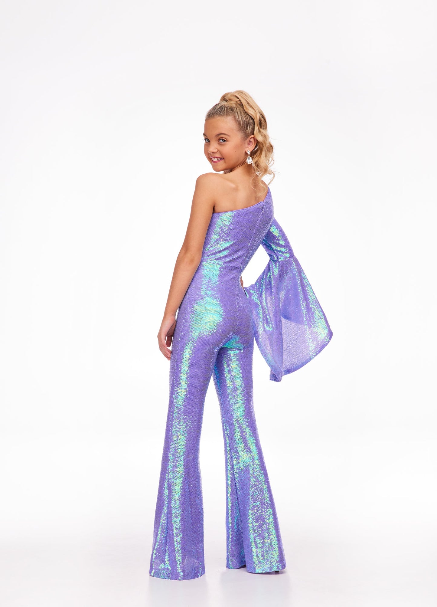 Ashley Lauren Kids 8110 One Shoulder Jumpsuit Long Bell Sleeve Sequin Pageant This groovy one shoulder jumpsuit features an oversized bell sleeve and flared pants. One Sleeve Oversized Bell Sleeve Sequin Fabric Jumpsuit Available Sizes: 2-16 Available Colors: Coral, Lilac, Yellow, Neon Green